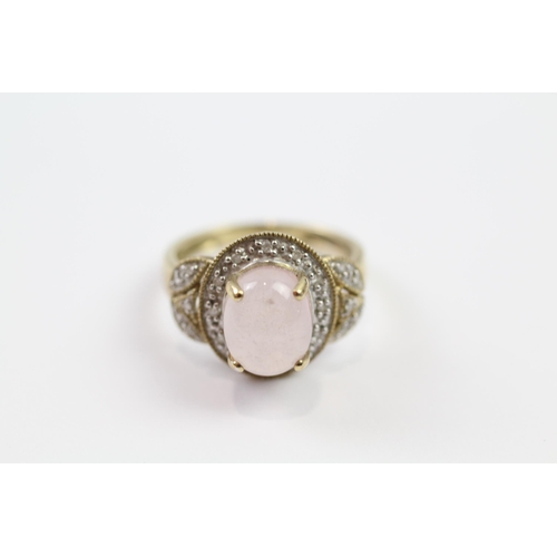 145 - 9ct gold rose quartz oval cabochon single stone ring with diamond surround (3.3g) Size  M