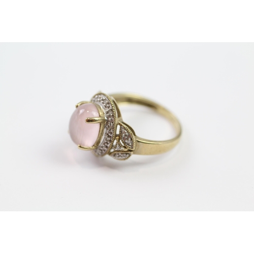 145 - 9ct gold rose quartz oval cabochon single stone ring with diamond surround (3.3g) Size  M