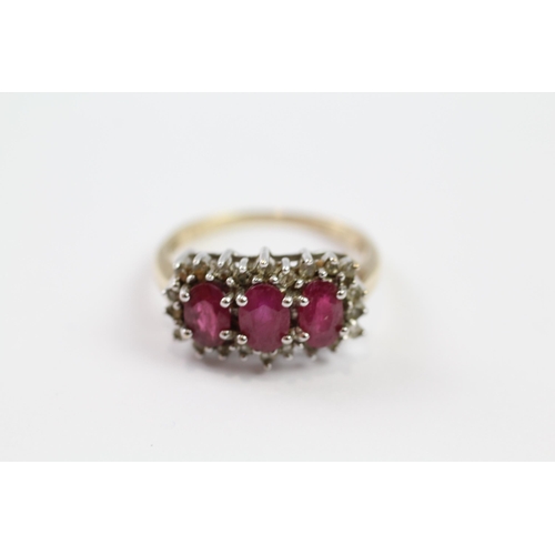 178 - 9ct gold synthetic ruby three stone ring with diamond frame (3.2g) Size  M