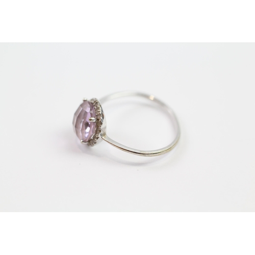 194 - 9ct white gold diamond & amethyst halo ring (1.2g).  Band slightly misshaped  Size  N