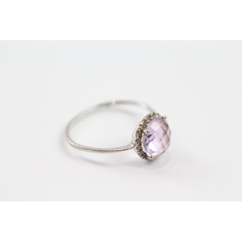 194 - 9ct white gold diamond & amethyst halo ring (1.2g).  Band slightly misshaped  Size  N