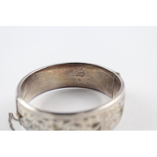 203 - Silver bangle with scrolling foliate etched design by Georg Jensen (64g)