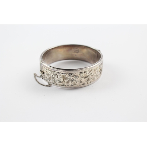 203 - Silver bangle with scrolling foliate etched design by Georg Jensen (64g)