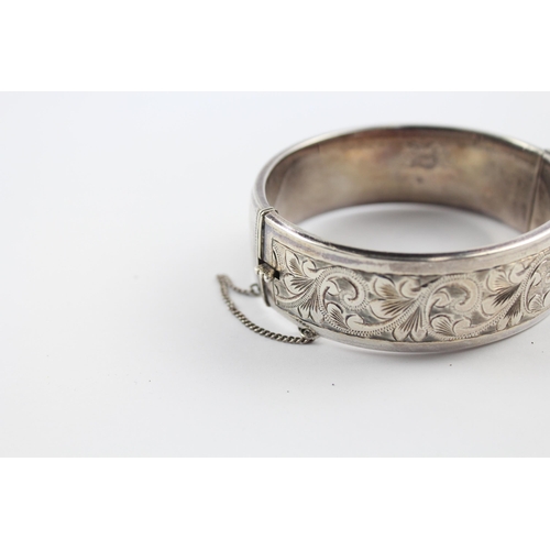 203 - Silver bangle with scrolling foliate etched design by Georg Jensen (64g)