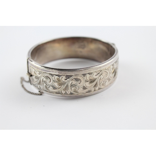 203 - Silver bangle with scrolling foliate etched design by Georg Jensen (64g)