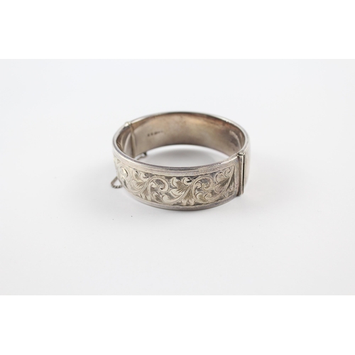 203 - Silver bangle with scrolling foliate etched design by Georg Jensen (64g)