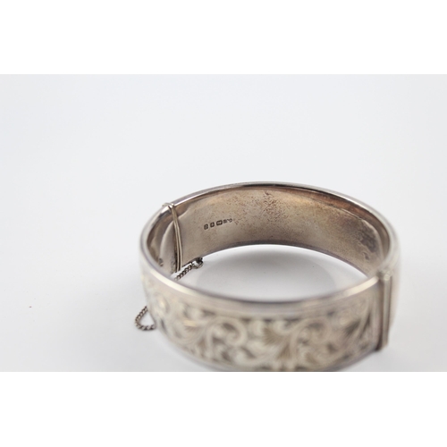 203 - Silver bangle with scrolling foliate etched design by Georg Jensen (64g)