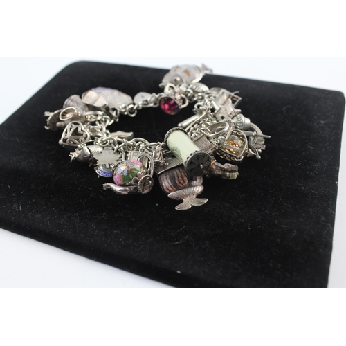 210 - Silver charm bracelet including emergency money charm (145g)