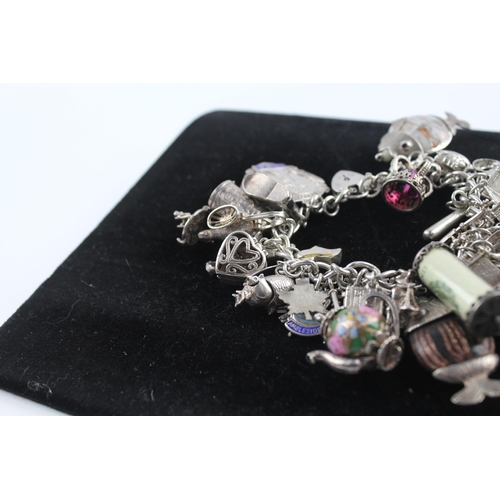 210 - Silver charm bracelet including emergency money charm (145g)