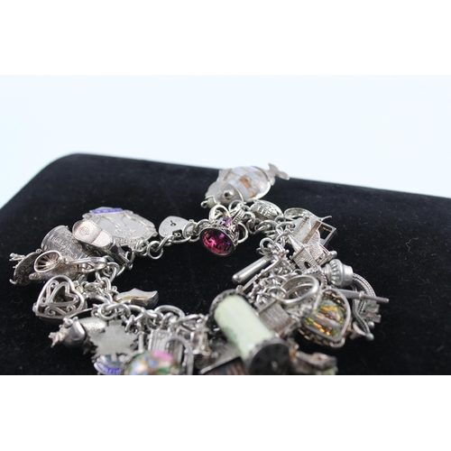 210 - Silver charm bracelet including emergency money charm (145g)