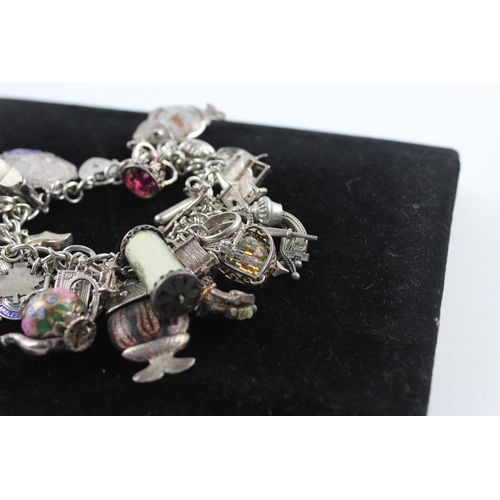 210 - Silver charm bracelet including emergency money charm (145g)