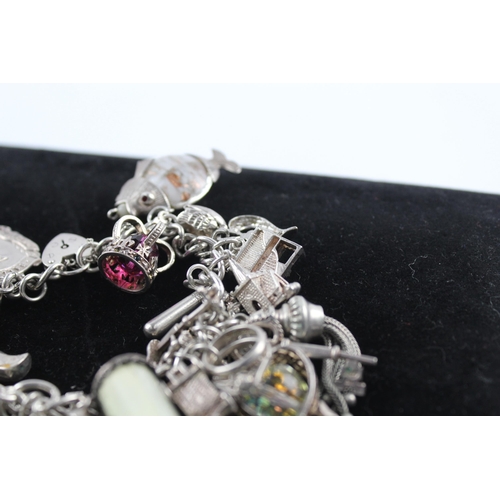 210 - Silver charm bracelet including emergency money charm (145g)