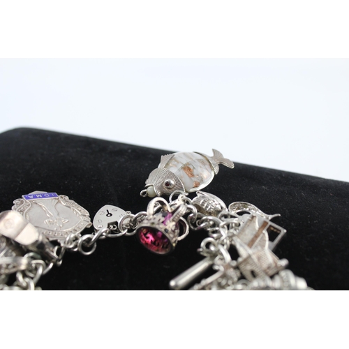 210 - Silver charm bracelet including emergency money charm (145g)