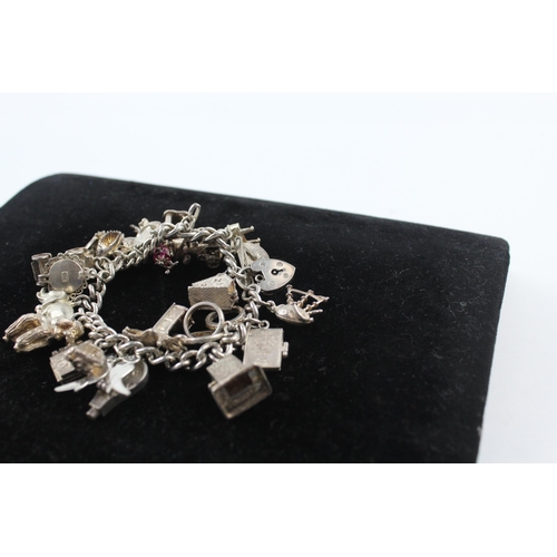 211 - Silver charm bracelet including opening charms (88g)