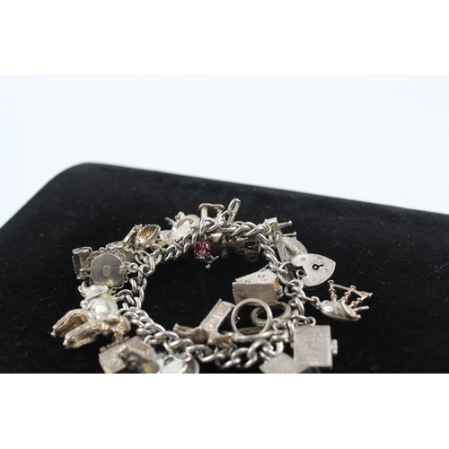 211 - Silver charm bracelet including opening charms (88g)