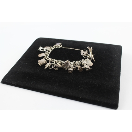 215 - Silver charm bracelet including souvenir charms (68g)