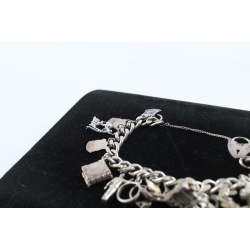 215 - Silver charm bracelet including souvenir charms (68g)