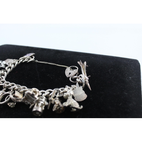 215 - Silver charm bracelet including souvenir charms (68g)