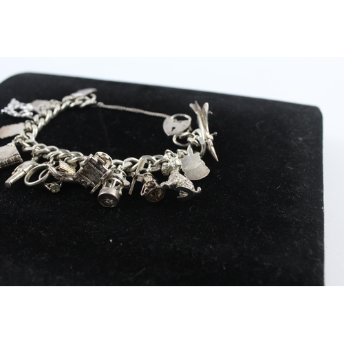 215 - Silver charm bracelet including souvenir charms (68g)