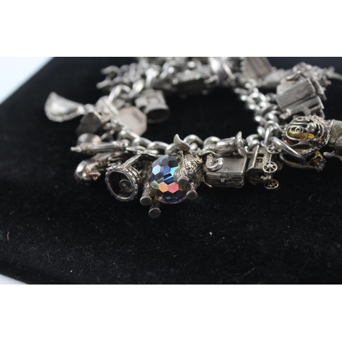 217 - Silver charm bracelet including opening charms (150g)