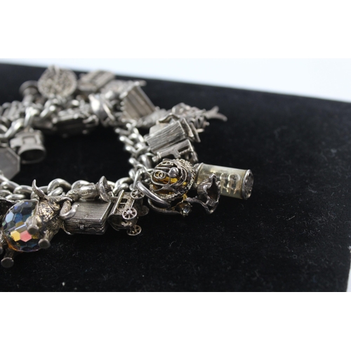 217 - Silver charm bracelet including opening charms (150g)