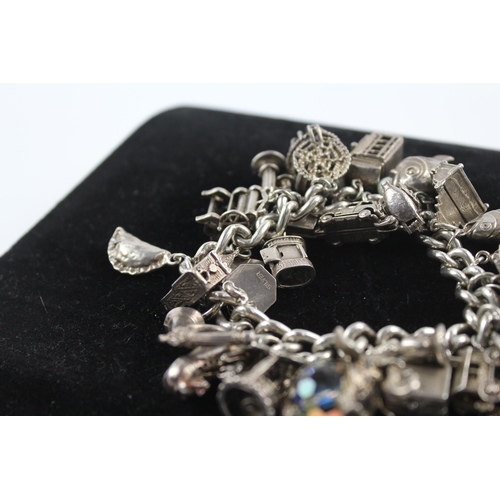 217 - Silver charm bracelet including opening charms (150g)