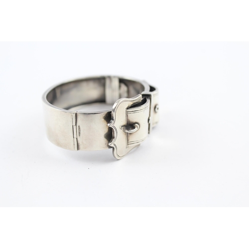 219 - Silver antique bangle with buckle design (34g)