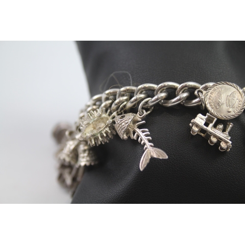 231 - Silver charm bracelet including opening charms