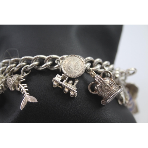 231 - Silver charm bracelet including opening charms