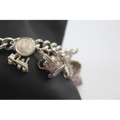 231 - Silver charm bracelet including opening charms