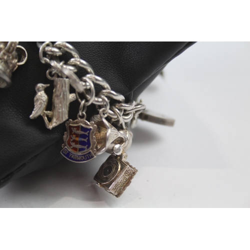 231 - Silver charm bracelet including opening charms