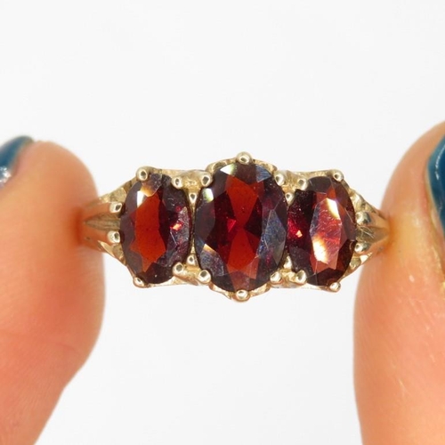 120 - 9ct gold garnet three stone ring (2.6g) Size  N