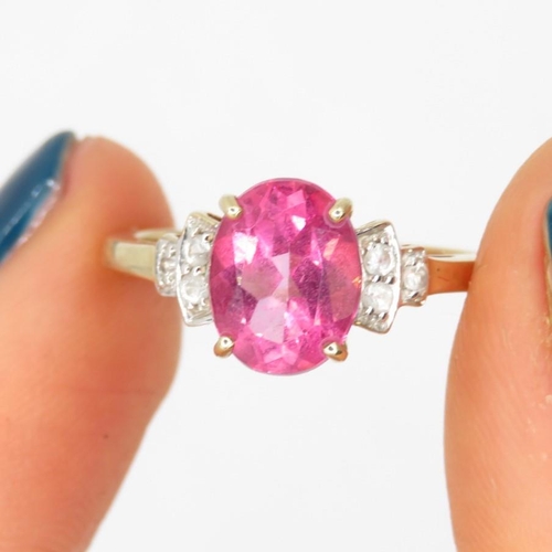 197 - 9ct gold coated pink topaz single stone ring with white gemstone sides (2.4g) Size  M