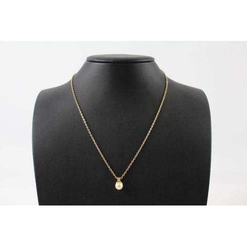 184 - Gold tone necklace with faux pearl pendant by designer Christian Dior