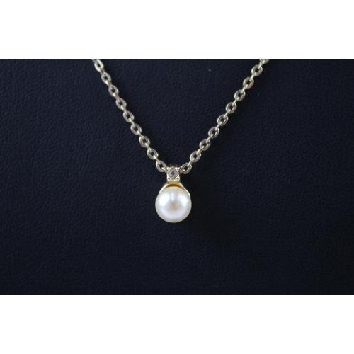 184 - Gold tone necklace with faux pearl pendant by designer Christian Dior