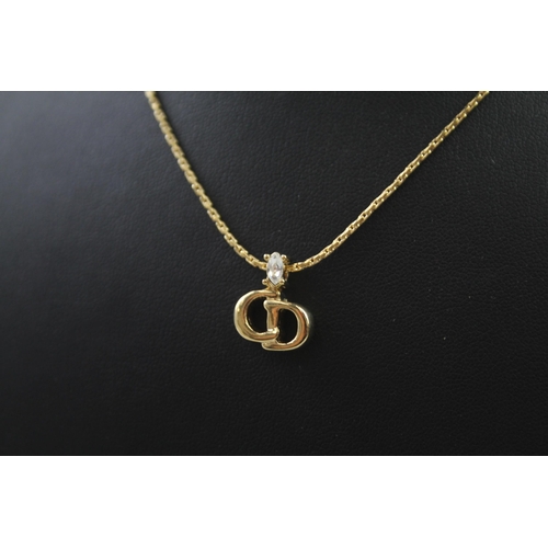 207 - Gold tone necklace with logo pendant by designer Christian Dior