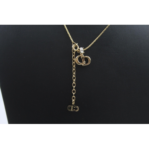 207 - Gold tone necklace with logo pendant by designer Christian Dior