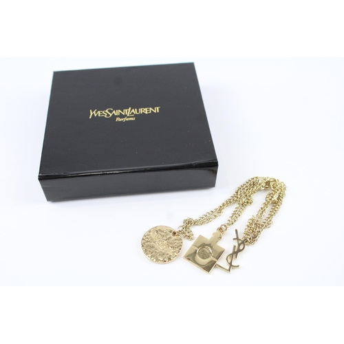 218 - Gold tone parfum charm bracelet by designer YSL with box