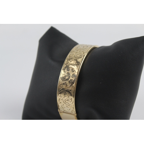 226 - 9ct rolled gold bangle with etched scrolling foliate design