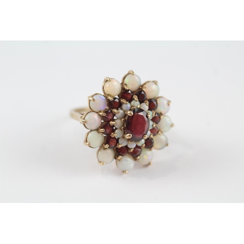 69 - 9ct gold white opal & garnet floral cluster cocktail ring (6.2g) Size  P 1/2