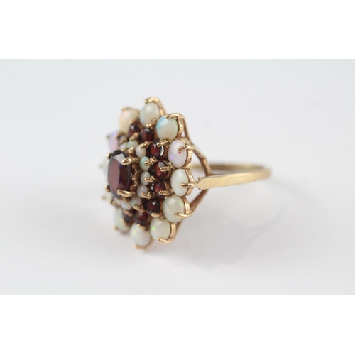 69 - 9ct gold white opal & garnet floral cluster cocktail ring (6.2g) Size  P 1/2