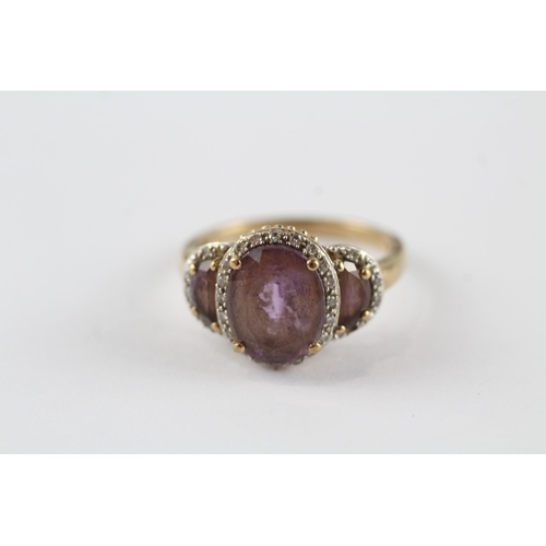 96 - 9ct gold amethyst three stone ring with diamond frame (3.3g) Size  N