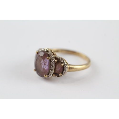 96 - 9ct gold amethyst three stone ring with diamond frame (3.3g) Size  N