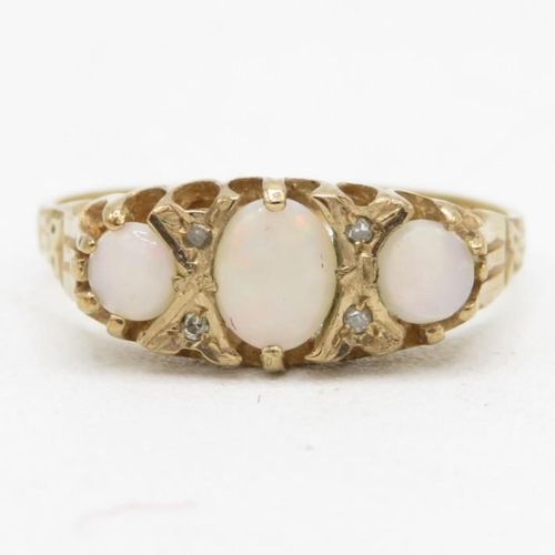 84 - 9ct gold white opal three stone ring with diamond spacers (1.5g) Size  K