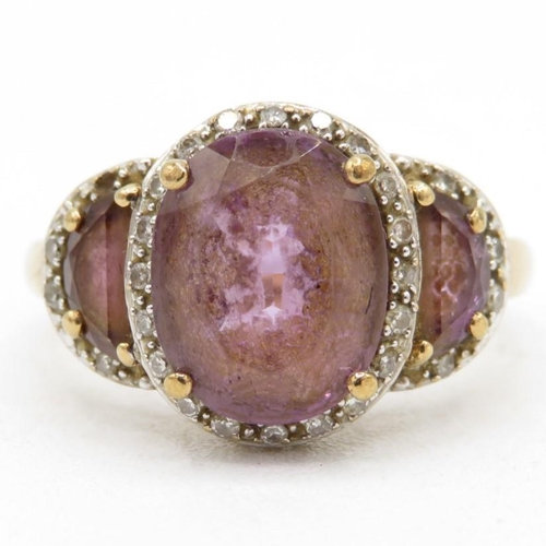 96 - 9ct gold amethyst three stone ring with diamond frame (3.3g) Size  N