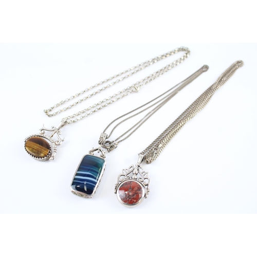 173 - Three silver double sided gemstone necklaces including spinner