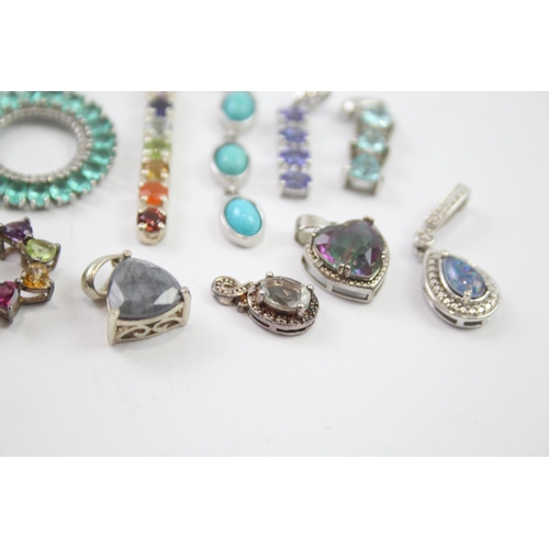 182 - A collection of silver gemstone pendants including Tanzanite