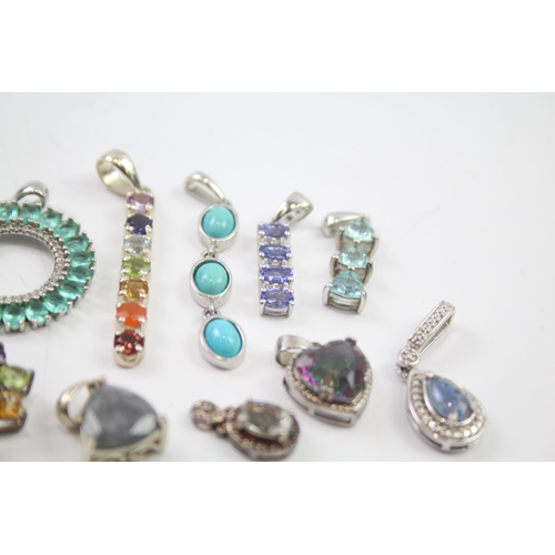 182 - A collection of silver gemstone pendants including Tanzanite