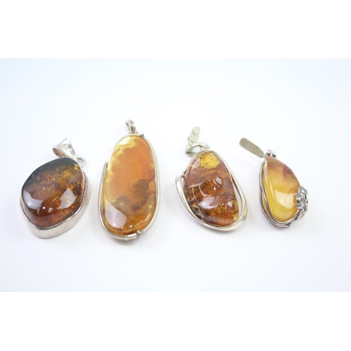 184 - Four silver Amber pendants including Baltic