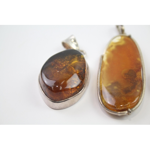 184 - Four silver Amber pendants including Baltic